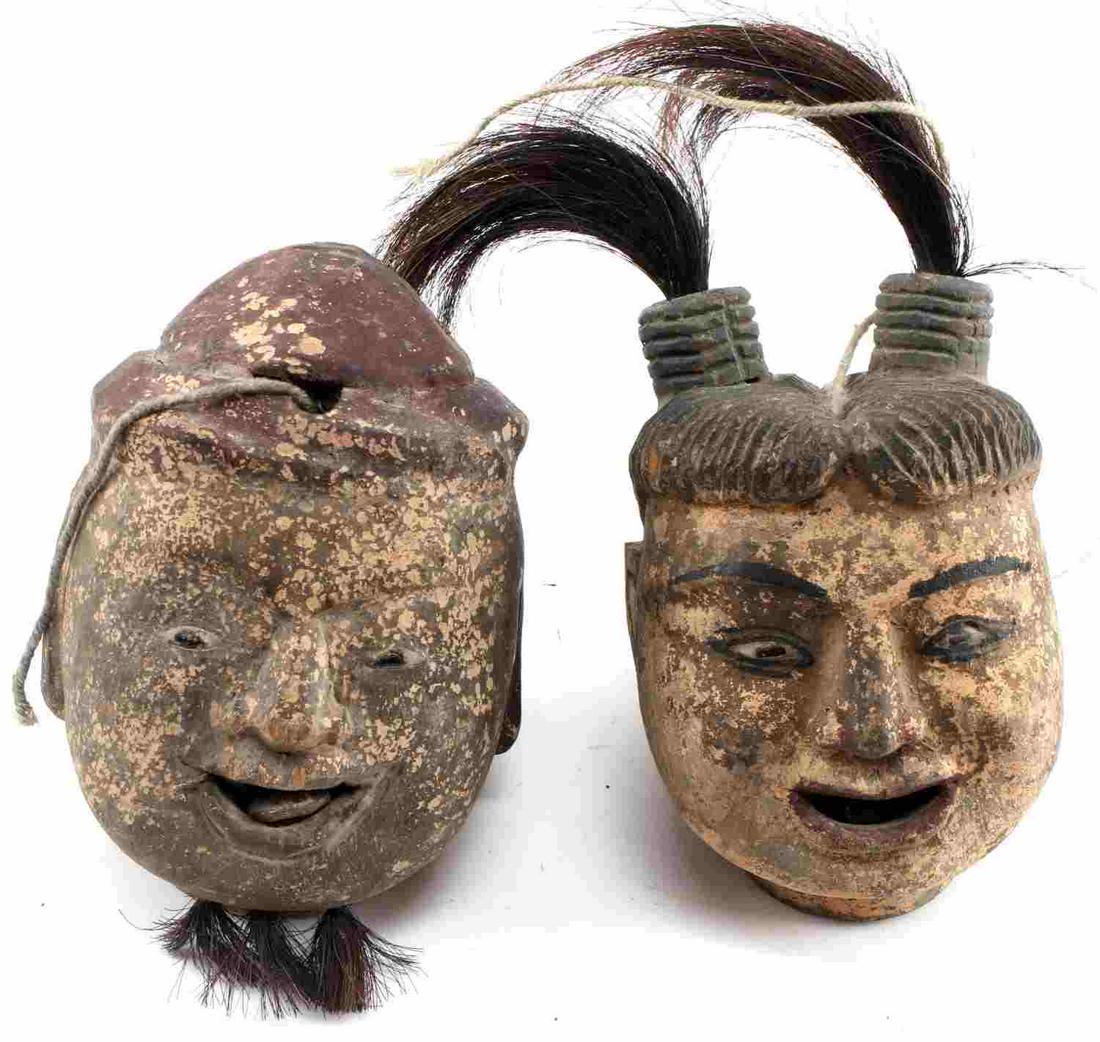 19TH CENTURY ASIAN CARVED WOOD PUPPET HEAD LOT: Pair of Asian 19th century hand carved, painted marionette puppet heads with motile tongue piece with string intact. 11cm x 20cm each. This lot has a reserve.