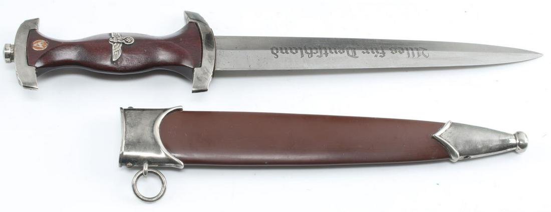WWII GERMAN THIRD REICH SA DAGGER AND SCABBARD: WWII German Third Reich SA Dagger and Scabbard. The blade has a makers mark of RZM M7/85. On the reverse side "alles fur deutchland" is inscribed. The cross guard is loose. The handle is made of walnu