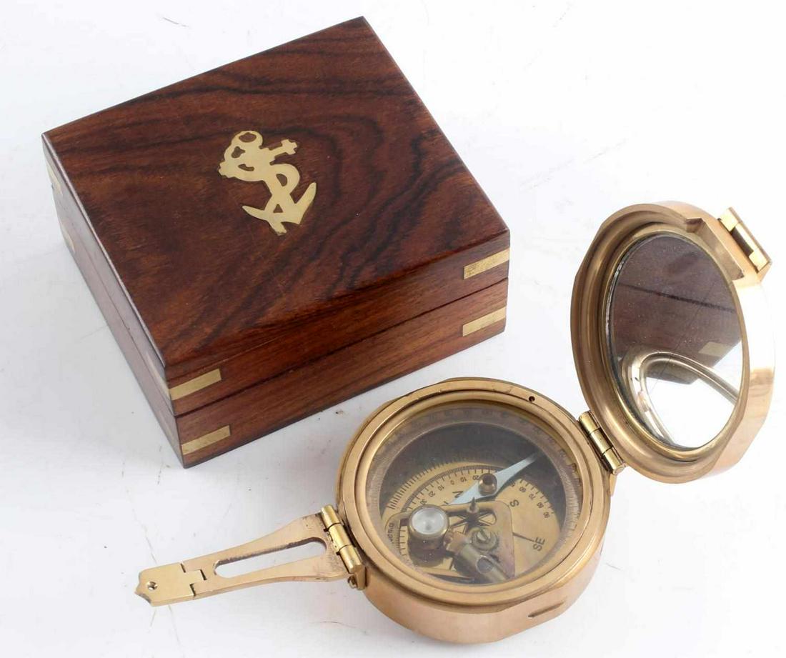 STANLEY LONDON ENCASED BRASS NAVAL COMPASS: Stanley London Encased Brass Naval Compass. Non-working order, measures 3.25 in diameter. Case measures 4 by 4.5 by 2 inches. Large anchor on the front of the case. Good condition.