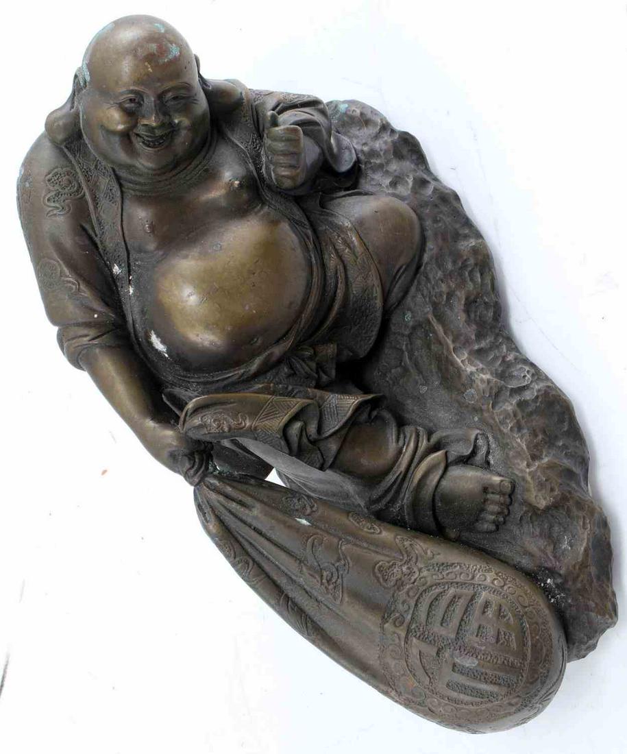 RECLINING BRASS SMILING BUDDHA STATUE: Reclining Brass Smiling Buddha Statue. There is oxidation throughout the statue. 9 inches in length, 5.5 inches long and 4 inches wide. Four legs support the statue. Good condition.