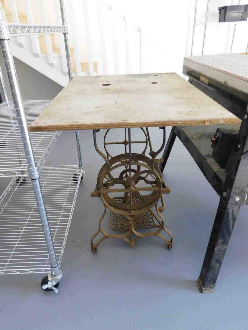 ANTIQUE SEWING MACHINE TABLE LOWER IRON WOOD: Rough wood for table top and the bottom is an old iron bottom to an antique sewing machine. Fair condition. See photos.