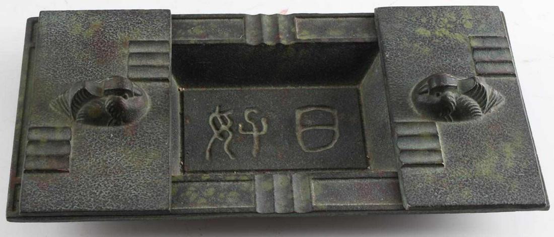 ANTIQUE METAL EAST ASIAN CIGAR TRAY W INSCRIPTION: Base tray has central recessed section with writing and a recessed section at either side. Two sliding lids at top each showing a water fowl at top. Depressions to place cigars or cigarettes at edges.