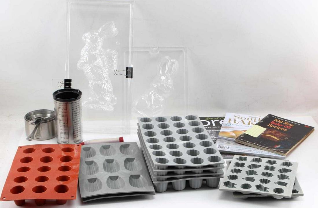 SILICON CHOCOLATE MOLD PANS & MEASURING CUPS: Six silicon chocolate making molds which are brand new and have never been used. Three baking recipe magazines. One multiple metric measuring cup. Six metallic measuring cups.