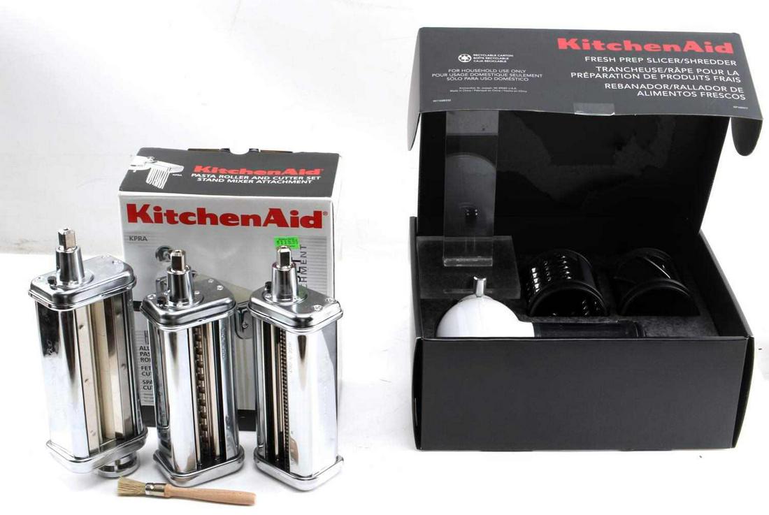 KITCHEN AID PASTA ROLLER FRESH PREP SHREDDER LOT: Lot of Two Kitchen Aid Appliances. The lot includes one Pasta Roller and Cutter Stand Mixer attachment and one Fresh Prep Slicer/Shredder Stand Mixer attachment. Both items are in very good condition 