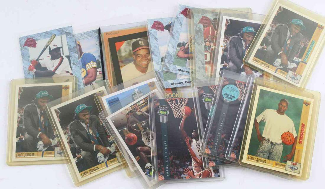 BASEBALL AND BASKETBALL ROOKIE CARD LOT OF 18: Lot includes one Dmittri Young Rookie Card, three Manny Ramirez Rookie Cards, two Frank Thomas Rookie Cards, five Larry Johnson Rookie Cards,one Stacy Augmon Rookie Card, five Shaq Rookie Cards and on