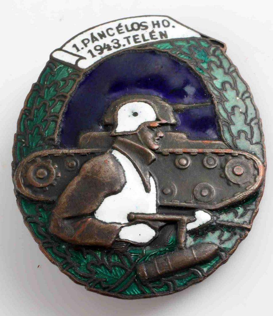 WWII HUNGARIAN 1ST ARMORED TANK DIVISION BADGE: WWII Hungarian 1st Armored Tank Division Badge. Multi Colored Enamel with helmeted soldier walking with tank. Equivalent to German Panzer Assault Badge. Very good condition. This lot has a reserve.