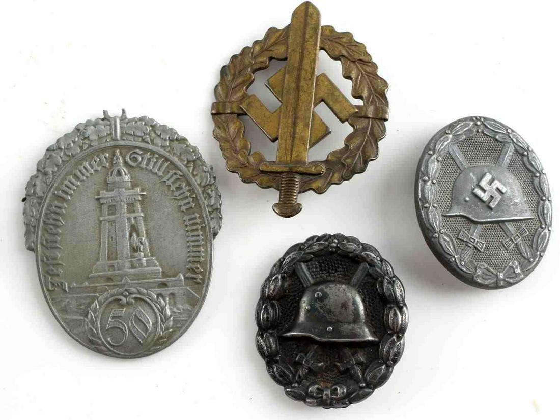 WWI & WWII GERMAN WAR BADGES & PINS: Prussian National Association 50 year membership pin measuring 3 inches by 2 inches (vertical pin structure missing). Gold colored SA sports badge with vertical pin measuring 2 inches by 1.75 inches. 