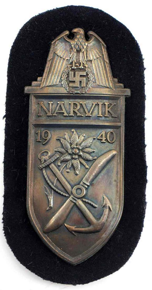 WWII GERMAN THIRD REICH NARVIK CAMPAIGN SHIELD: WWII German Third Reich Narvik Campaign Shield Type B. Composed of Matte Gilt Zinc given to the Kriegsmarine. Measures 4.25 by 2 inches. Very good condition.