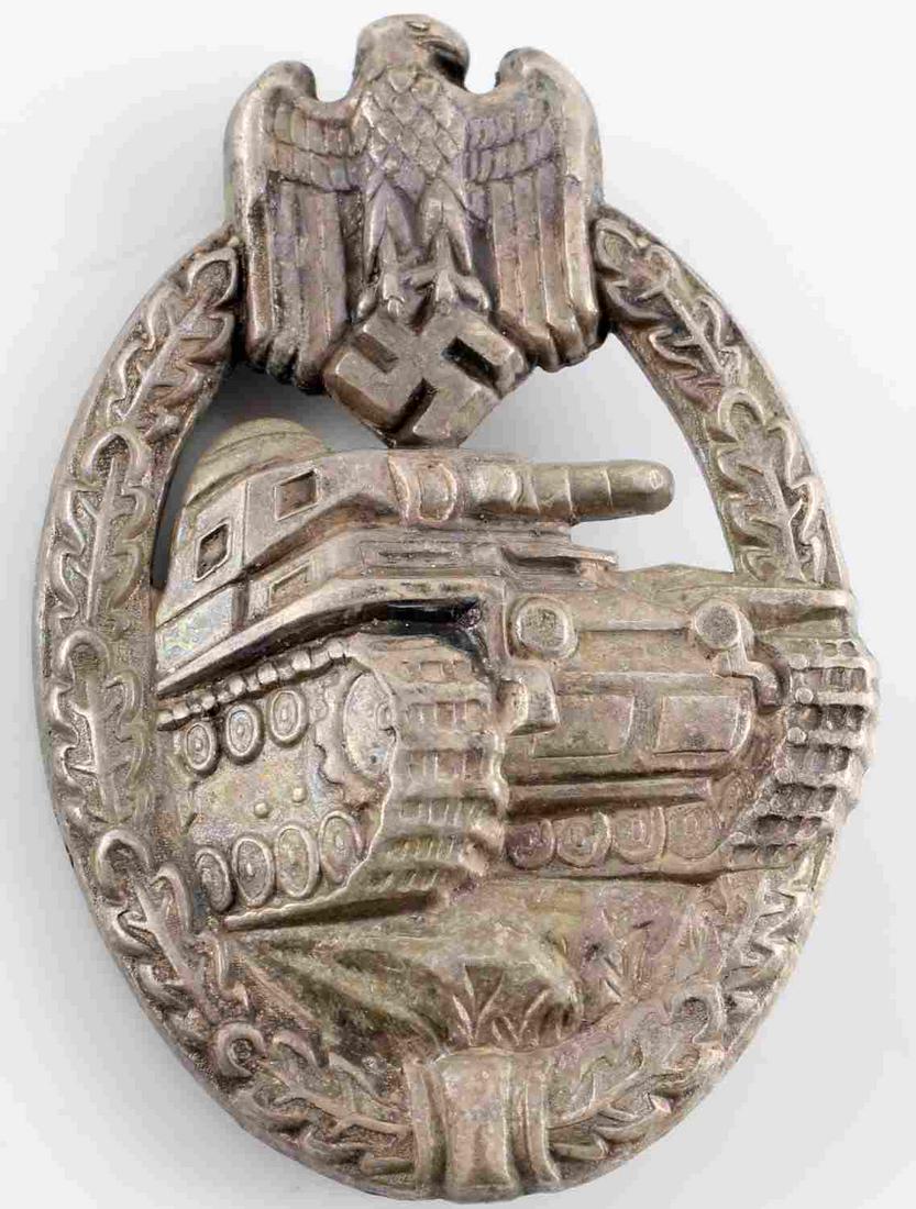 WWII GERMAN WEHRMACHT SILVER TANK ASSAULT BADGE: German WWII Army Silver Tank Assault Badge. The front shows a tank in the center with an army eagle clutching a swastika in his talons at the top. Both are surrounded by an oval oak leaf wreath. Has a