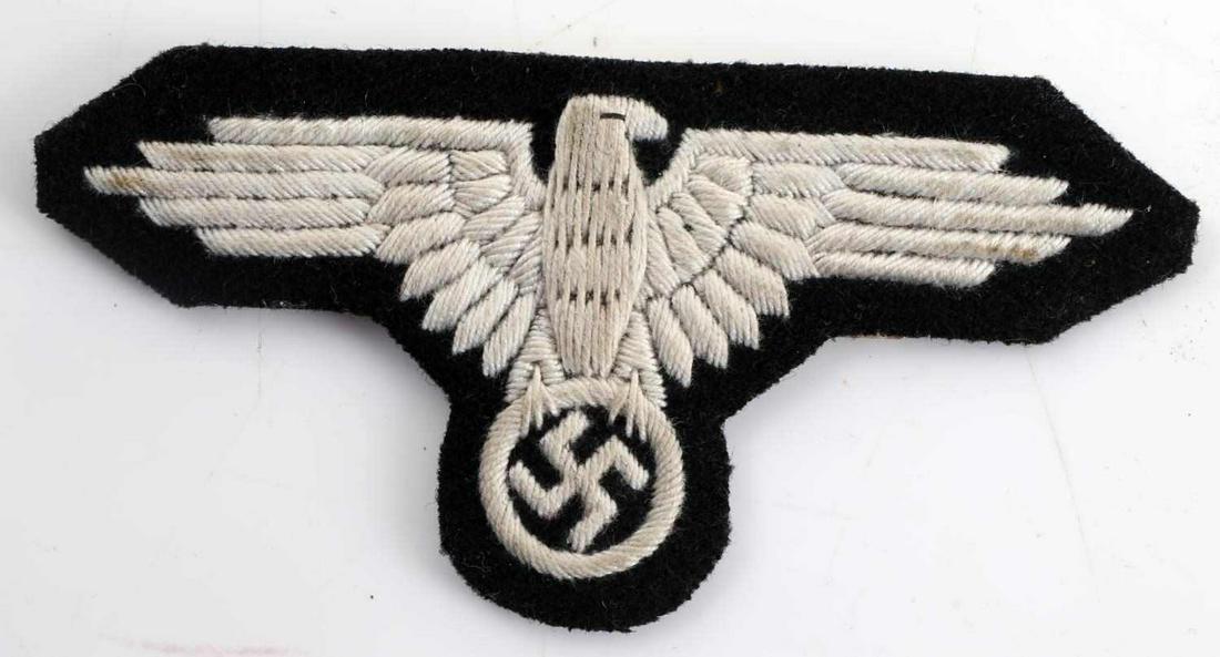 WWII GERMAN THIRD REICH OFFICER SS SLEEVE EAGLE: WWII German Third Reich Officer SS Sleeve Eagle. Makers mark of "RZM Berfteller". SS label on the rear of the eagle. First Pattern and hand embroidered in aluminum thread. Very good condition.