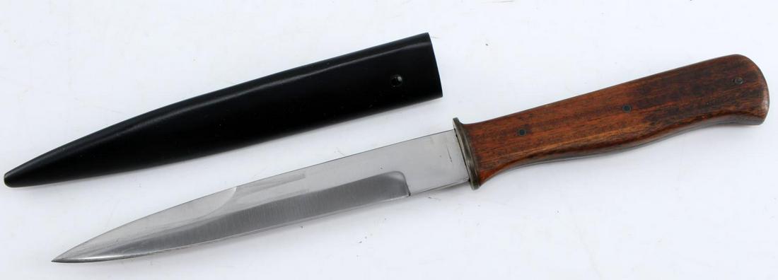 WWII GERMAN THIRD REICH TRENCH FIGHTING KNIFE: WWII German Third Reich Trench Fighting Knife. The blade measures 6 inches. the entire knife measures 10.5 inches. No makers mark. Wooden handle. Black steel scabbard. Very good condition. Unauthentic