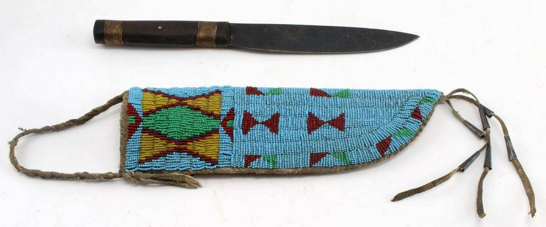 LAKOTA SOUIX SNAKE BLADE KNIFE & BEADED SHEATH: Snake brand Sheffield stamped blade, hand made measuring overall 11 inches, very good original condition, full obverse beaded scabbard with brain tanned leather with conicals, measuring 10 1/2 inches.