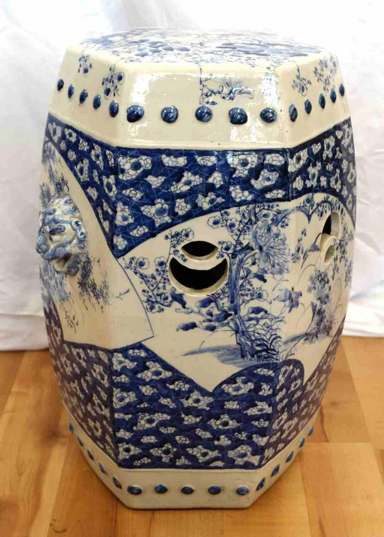 PORCELAIN CHINESE BLUE & WHITE FOO DOG STOOL: Porcelain blue and white drum (hollow on inside) Chinese garden stool measuring 23 inches high and 11 inches in diameter with Foo dog adornments and Chrysanthemum motif. Fully porcelain on both inside