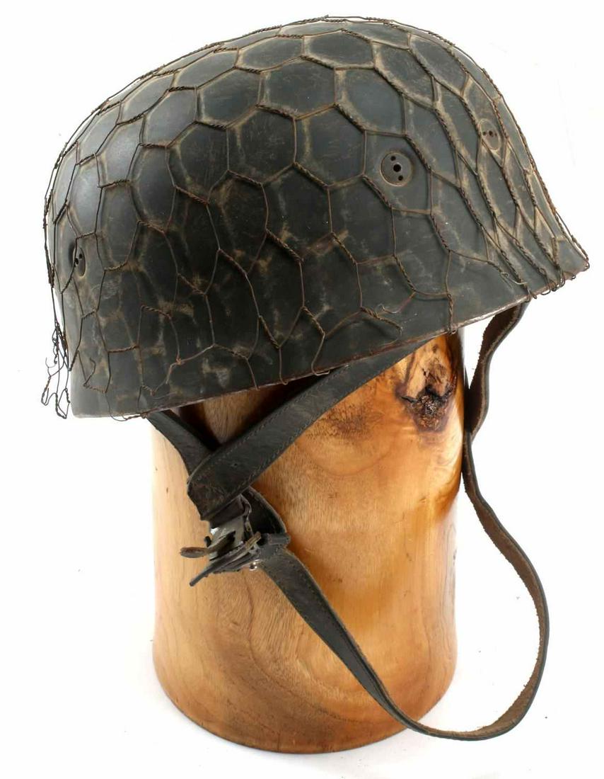 WWII GERMAN 3RD REICH LUFTWAFFE PARATROOPER HELMET: WWII German Third Reich Luftwaffe Paratrooper Helmet. Double decal style with chicken wire around the helmet. Complete with liner and chin strap. Some of the wire is coming loose. Very good condition.