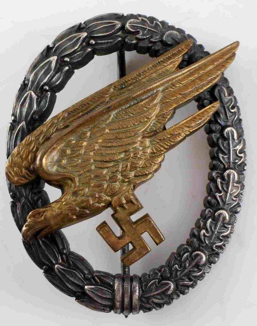 WWII GERMAN 3RD REICH LUFTWAFFE PARATROOPER BADGE: WWII German Third Reich Luftwaffe Paratrooper Badge. Vertical pin back with makers mark of "G.H. Osang Dresden". Some oxidation on the eagle with finish loss on the oak wreath. Very good condition.