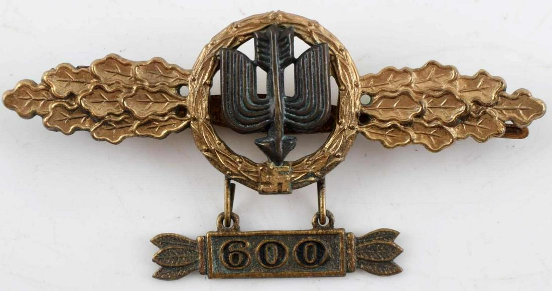 WWII GERMAN LUFTWAFFE LONG RANGE FIGHTER 600 CLASP: WWII German Third Reich Luftwaffe Long Range Fighter 600 Clasp in Gold. Makers mark of "B & N L". Heavy surface patina on the "600" pendant and rear of the clasp. Very good condition.