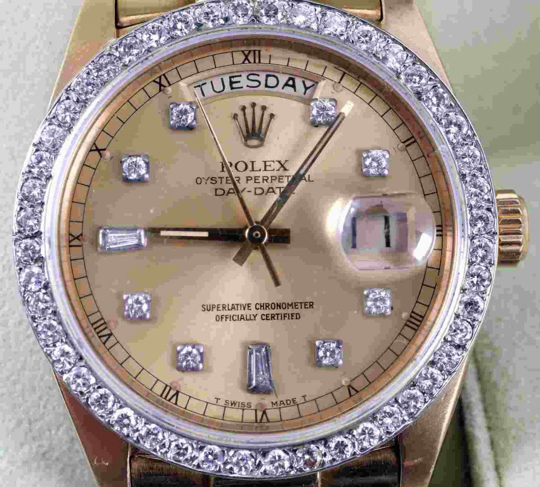 18KT DIAMOND ROLEX OYSTER PERPETUAL MENS WATCH: Late '80's to early 90's production. .52 TCW 18K yellow gold Oyster Perpetual Day Date Rolex watch, with 47 1.25 mm round cut diamonds framing dial and 10 1 mm diamonds within dial. Eye clean diamonds