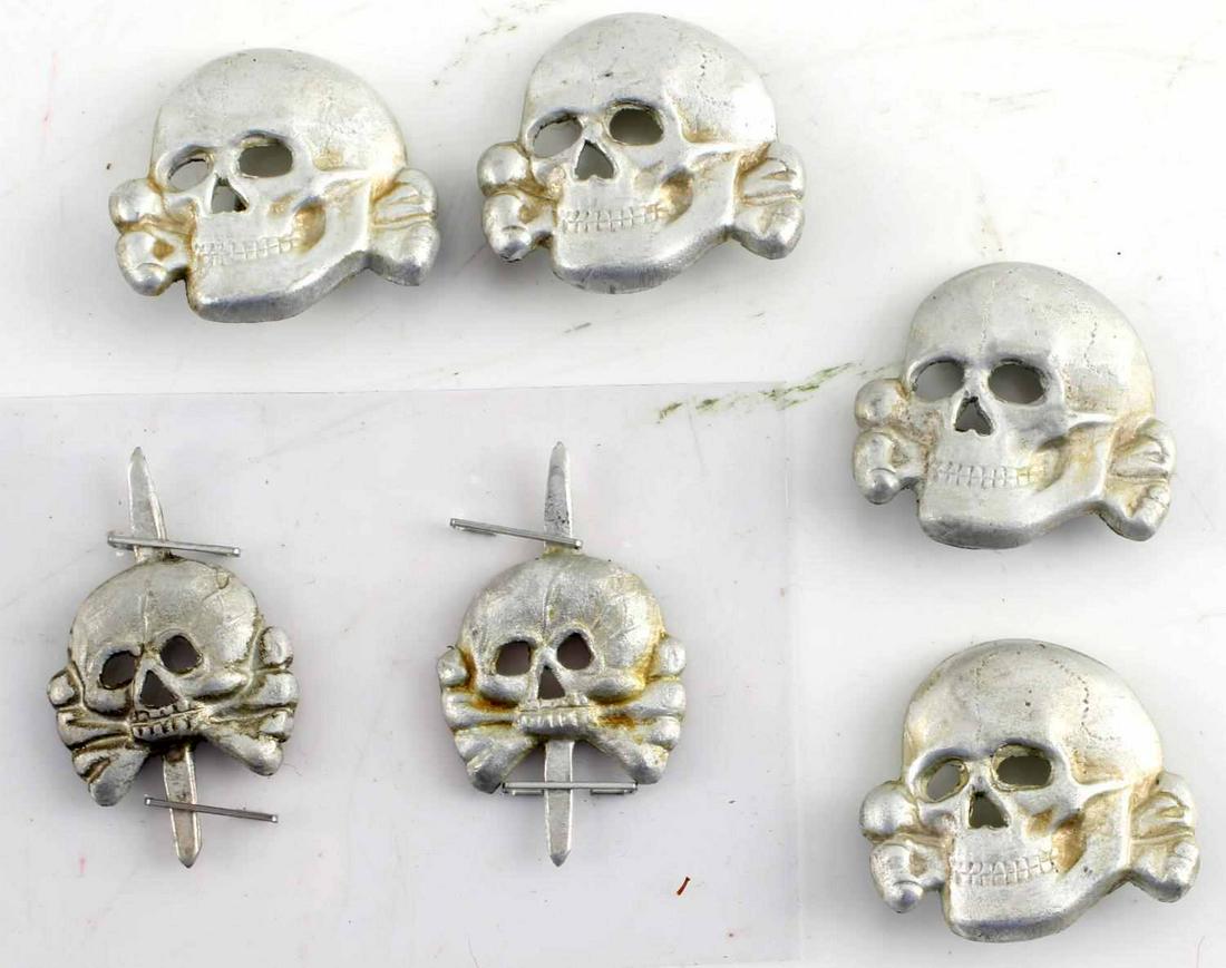 WWII THIRD REICH GERMAN TOTENKOPF INSIGNIA PANZER: Six Totenkopf insignia: four badges measuring 1 inch, and two Panzer insignia measuring .75 inches.Unauthenticated, sold as is. This lot has a reserve.