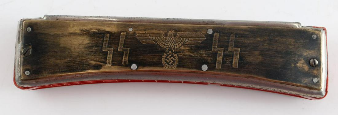 WWII GERMAN THIRD REICH WAFFEN SS HARMONICA: WWII German Third Reich Waffen SS Harmonica. Measures 6 inches long, 1 inch deep and 1.5 inches wide. Nice patina to the bronze fittings. Very good condition. Unauthenticated; sold as is.