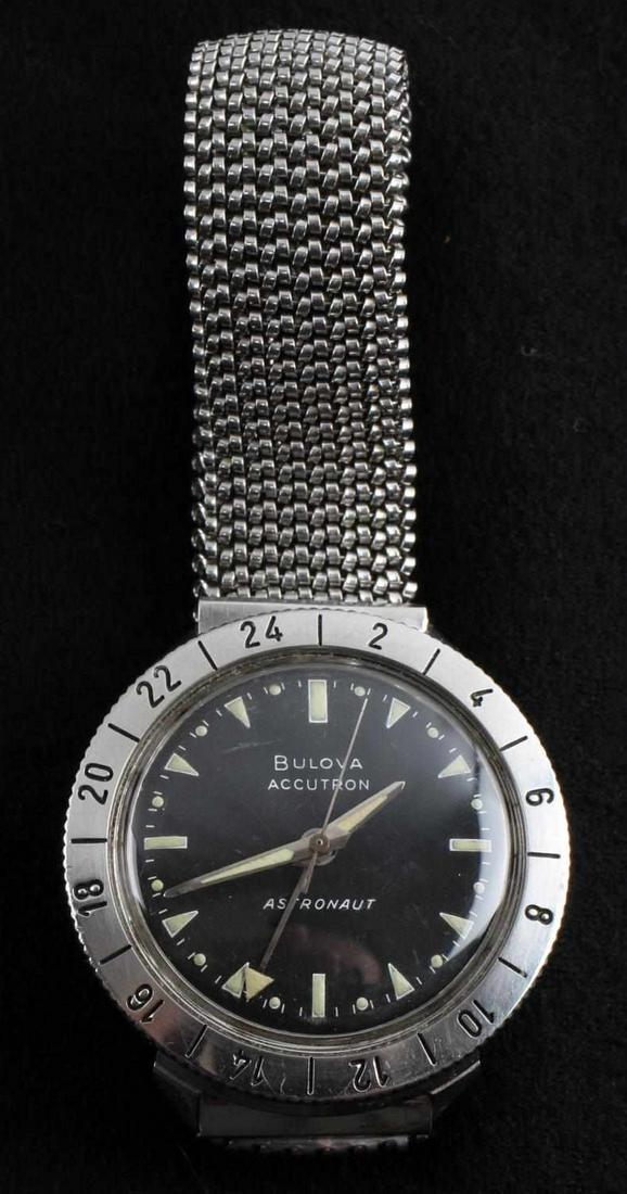 BULOVA ACCUTRON ASTRONAUT MENS WRISTWATCH: Matte black dial. The bezel is an engraved rotating 24 hour graduation and is 14k. Back of case is stamped "BULOVA WATERPROOF STAINLESS STEEL PATENTED"