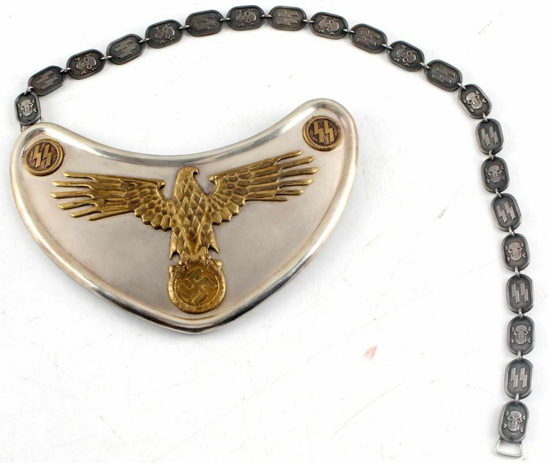 WWII GERMAN THIRD REICH SS FLAGBEARER GORGET: S.S. GORGET MODEL 1938. Large Eagle holding wreathed swastika. Two buttons hold S.S. runes. Leather back. Chain has 21 oval links of alternating “SS” runes & skull and cross bones. Marked “SS”