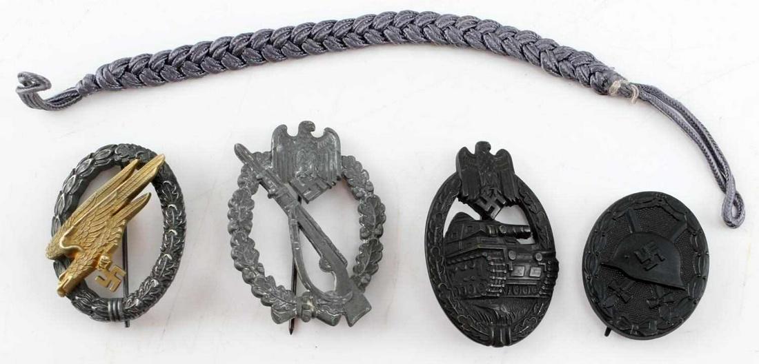 WWII THIRD REICH GERMAN WOUND & PANZER BADGE: Lot of three insignia from WWII Third Reich Germany: solid black wound badge measuring 1.5 inches in diameter, bronze panzer tank crew badge with vertical pin structure measuring 1.7 inches in diamete