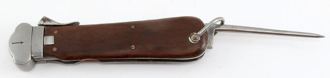 WWII GERMAN THIRD REICH PARATROOPER GRAVITY KNIFE: WWII German Third Reich Paratrooper Gravity Knife. The blade is stuck in the wooden handle. The spike is marked "BB NA 056170019" and measures 3.5 inches. There is some pitting on the fittings. The ha