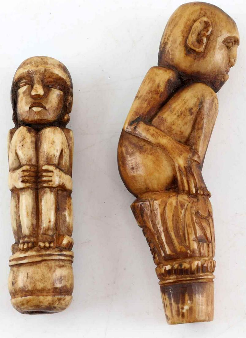 LOT OF TWO BONE CARVED ANTIQUE FIGURAL HANDLES: Both figures are shown crouched. Larger measures 3.75 inches by 1 inch. Smaller measures 3.25 inches by .75 inches. Both in very good condition.