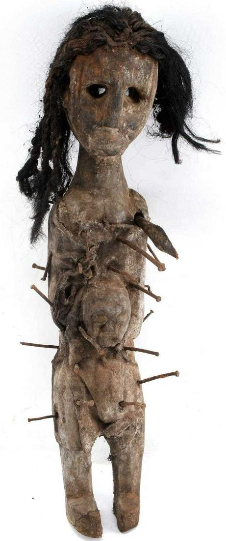KONGO AFRICAN TRIBAL NAIL FETISH FEMALE FIGURE: Hand carved standing female mother and child figure. Created from wood, textile, red clay, nails and a spear head through the shoulder. Height 25 inches.
