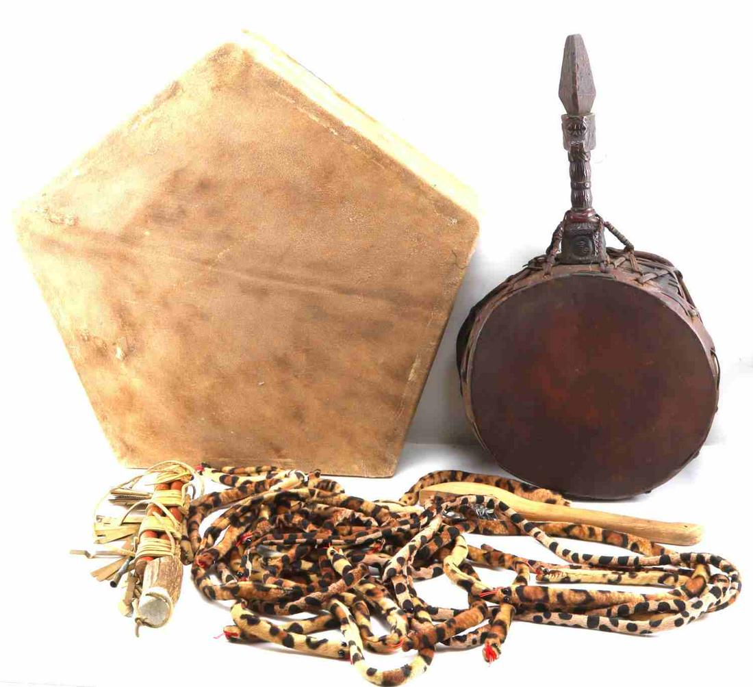 AFRICAN TRIBAL DRUM AND PERCUSSION INSTRUMENT LOT: 20th Century hand made African percussion instruments including 2 small rattles, a hide skin dancing hand drum and a drum/rattle with beautifully carved handle. This lot has a reserve.