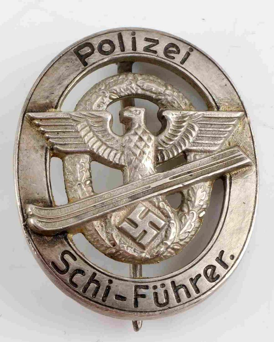 WWII GERMAN THIRD REICH POLIZEI SCHI FUHRER BADGE: WWII German Third Reich Polizei Schi Fuhrer Badge. Marked "800" for silver with a crown above. Vertical pin back. Some finish loss on the rear with slight abrasions on the front. Very good condition. 