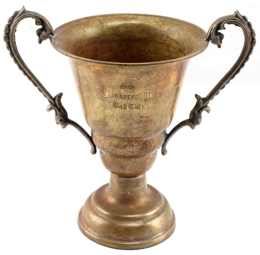 WWII THIRD REICH GERMAN BRASS SS SCHOOL AWARD: stamped SS Junkerschule Bad Toelz, an SS training school south of the Dachau Concentration Camp. Award cup measures 6 inches in height with a diameter of 4 inches. Brass is scratched and tarnished. Un