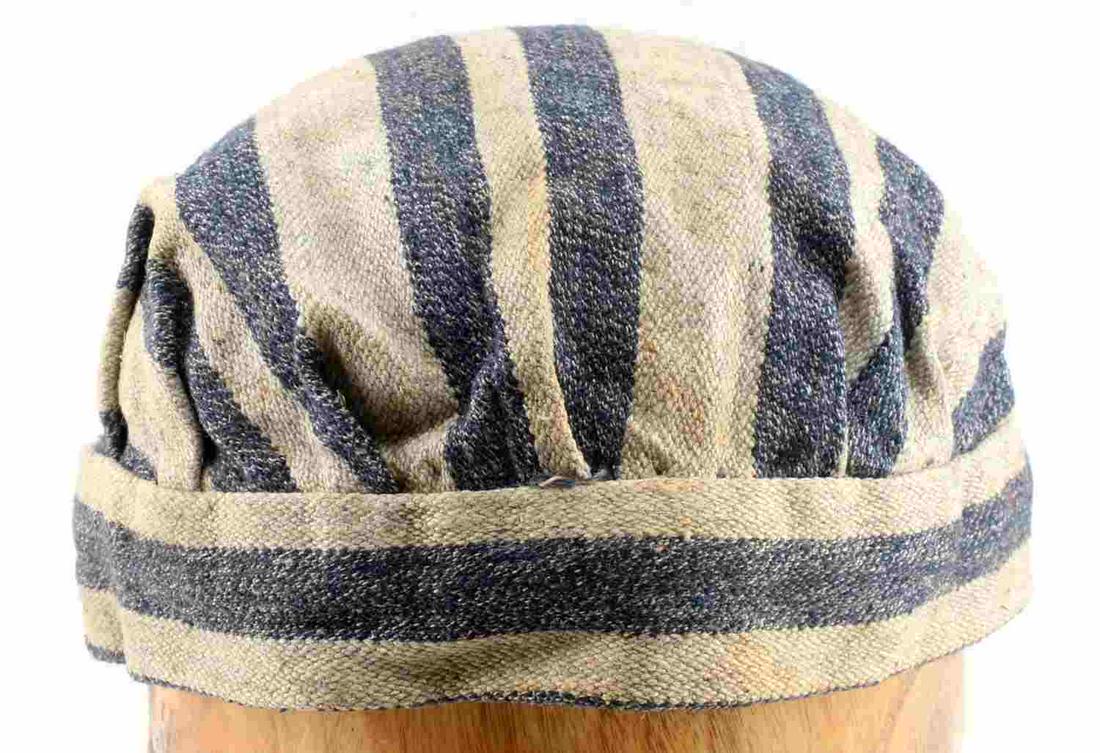 WWII GERMAN AUSCHWITZ CONCENTRATION CAMP CAP: WWII German Auschwitz Concentration Camp Cap. Measures 10 7/8" wide by 3 3/4” tall. The inside is stamped ‘Auschwitz’ in black ink. Two piece machine sewn blue and grey woven cotton construction