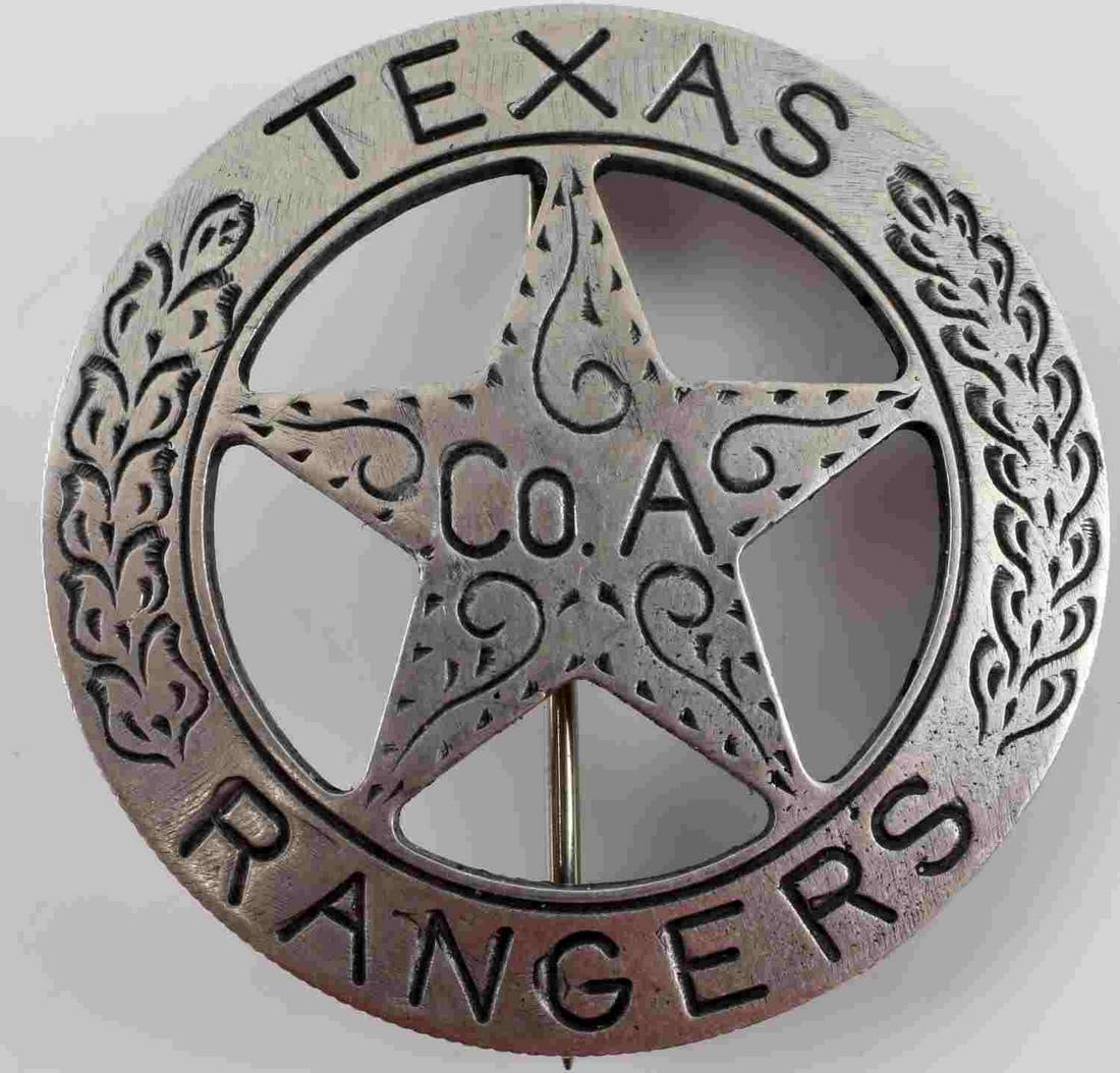 TEXAS RANGER COMPANY MEXICAN PESO LAW BADGE: Texas Rangers Company A Mexican Peso Law Badge. Measures 1 9/16” in diameter. The front reads ‘TEXAS RANGERS CO A’. There is an oak leaf design engraved on each side. The reverse side shows a Me