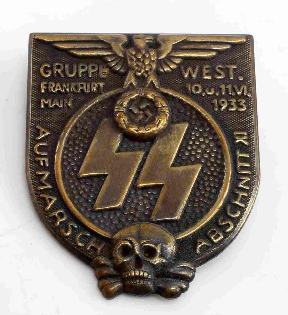 WWII THIRD REICH GERMAN SS FRANKFURT WEST BADGE: German WWII Waffen SS 1933 Frankfurt Gruppe West Badge. The front shows a German eagle clutching s swastika in his talons at the top. There is a pair of Waffen SS runes in the center and a skull and c