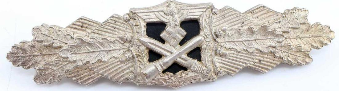 WWII THIRD REICH GERMAN SILVER CLOSE COMBAT CLASP: German WWII Army Silver Close Combat Clasp. The front has a German eagle clutching a swastika in his talons at the top with a cross bayonet and stick grenade below. All three are flanked by oak leaves