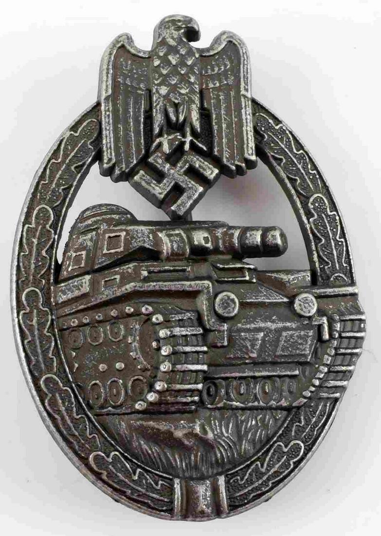 WWII GERMAN THIRD REICH SILVER TANK ASSAULT BADGE: German WWII Army Silver Tank Assault Badge. The front shows a tank in the center with a German eagle clutching a swastika in his talons at the top. Both are surrounded by an oval oak leaf wreath. The