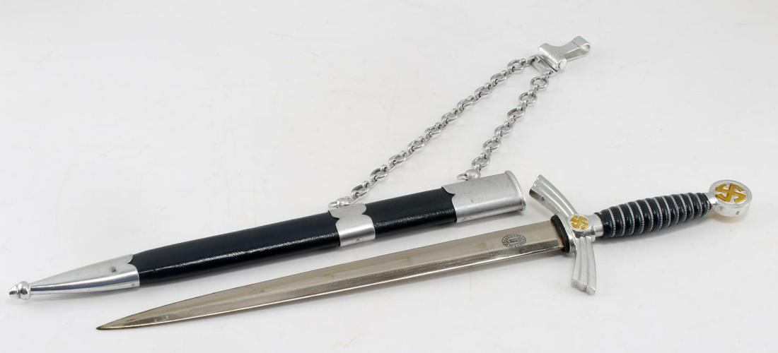 WWII THIRD REICH GERMAN LUFTWAFFE 1ST MODEL DAGGER: WWII German 1st Model Luftwaffe dagger and scabbard, the blade measuring 12 inches, 18 inches overall. The blade is stamped FW Holler Solingen, and the aluminum holt and pommel, with silver wire wrapp