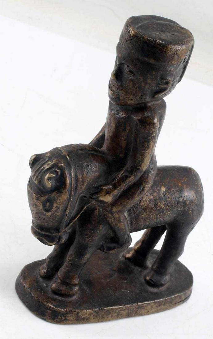 NIGERIAN BRASS EQUESTRIAN HORSE AND RIDER: Weight 4.2 pounds, 6X5X2 inches. In good condition This lot has a reserve.