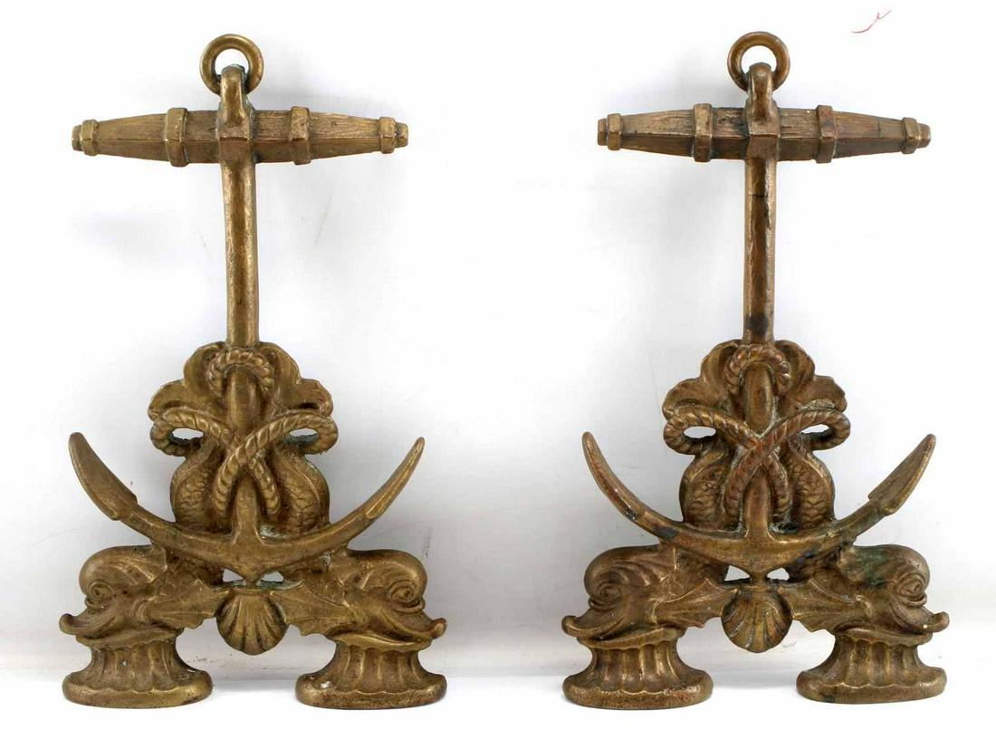 19TH CENTURY NAUTICAL DOLPHIN FIREPLACE ANDIRONS: Late 19th century brass nautical fireplace andirons fronts designed with fouled anchors with bundled rope around two dolphins resting on capstan feet and a clam shell motif in the bottom center. Rever