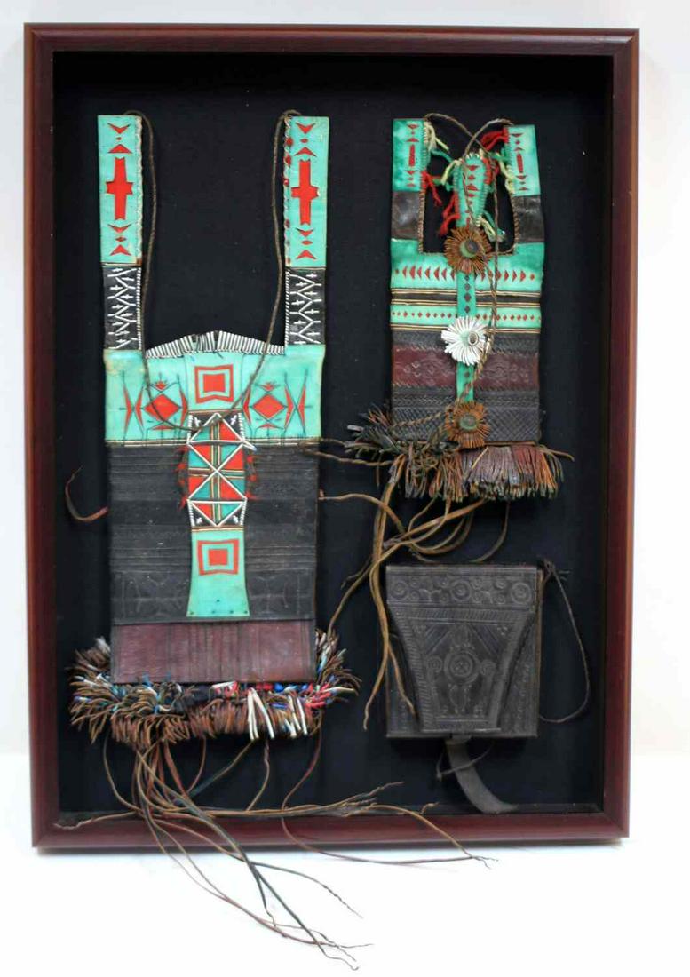 20TH CENTURY AFRICAN LEATHER WORKS DISPLAY: Shadow box style display, 24x18x2 inches, of 3 tooled and colorful multi layer leather work pieces by African Artisan.