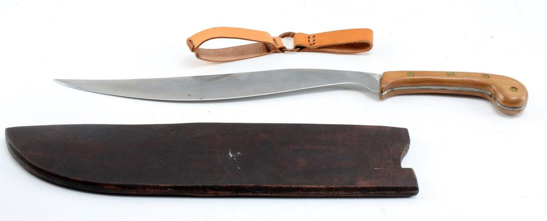 PHILIPPINE BOLO KNIFE MACHETE WITH SCABBARD: Philippine Bolo Knife. The knife measures 19.5 inches in length. Blade measures 13.5 inches. Handle is composed of wood. Wooden scabbard measures 15.5 inches. Comes with leather hanger. Very good cond