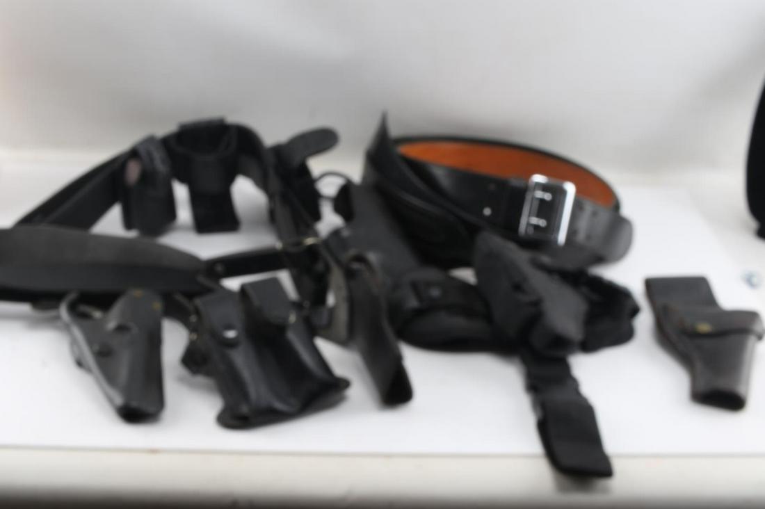 LOT OF POLICE LEATHER GUN HOLSTERS BELTS NYLON: Lot includes: Law Pro nylon and faux leather ammo belt (2XL), Mixson Leathercraft leather belt (71 36), Don Hume leather pistol holster (NO. 25 USP), nylon shoulder holster, tooled leather shoulder ho