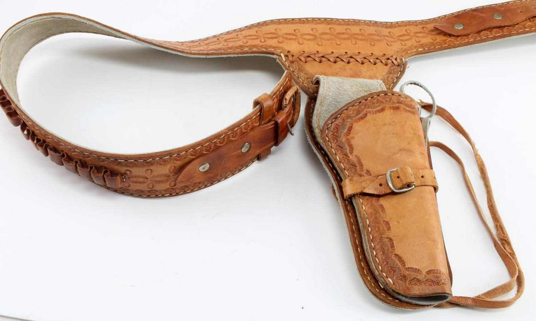 HAND TOOLED COLT SAA LEATHER HOLSTER AMMO BELT: Hand Tooled Colt SAA Revolver Leather Holster Ammo and Belt. Entire length is 42.5 inches. Nice punctuated southwestern design throughout the belt. Belt has 11 ammo loops. "36" is inscribed on the inn