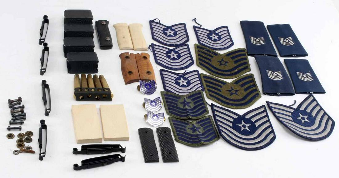 M-1 GARAND MAGAZINES USAF INSIGNIA PISTOL GRIPS: Lot includes 4 M-1 Garand magazines, Lee Enfield stripper clip with 5 spent rounds, NCO Air Force cloth and metal rank insignia, hand carved wood 2 3/4 inch pistol grips, and 1 plastic and more as pho