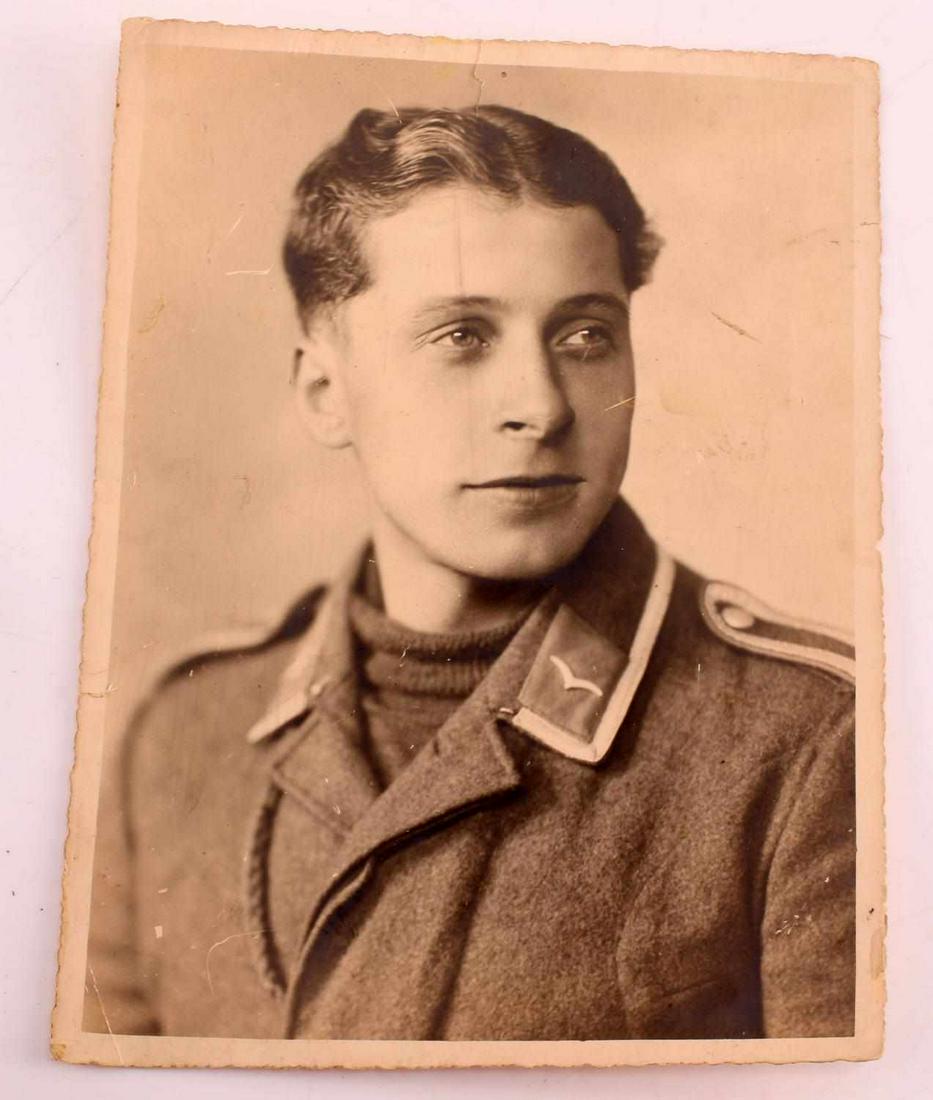 WWII GERMAN THIRD REICH LUFTWAFFE EM PHOTOGRAPH: WWII German Third Reich Luftwaffe Enlisted Man Photograph. Depicts a young enlisted man under Transport duties. Measures 9 by 6.75 inches. Some small rips on the photo. Good condition.