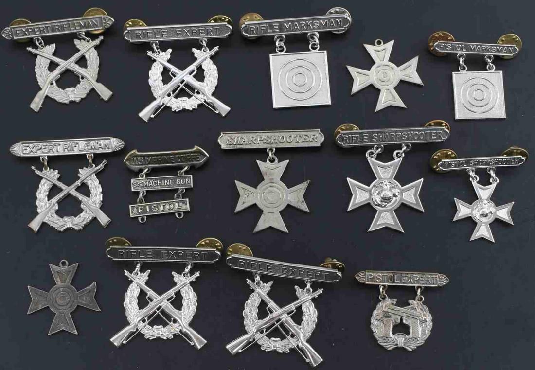 LOT OF 14 USMC RIFLE & PISTOL QUALIFICATION BADGES: Lot of 14 United States Army and Marine Corps Rifle and Pistol qualification badges. 1 USMC Rifle Sharpshooter badge. 1 USMC Pistol sharpshooter badge. 1 Sharpshooter badge. 2 sharpshooter crosses wit