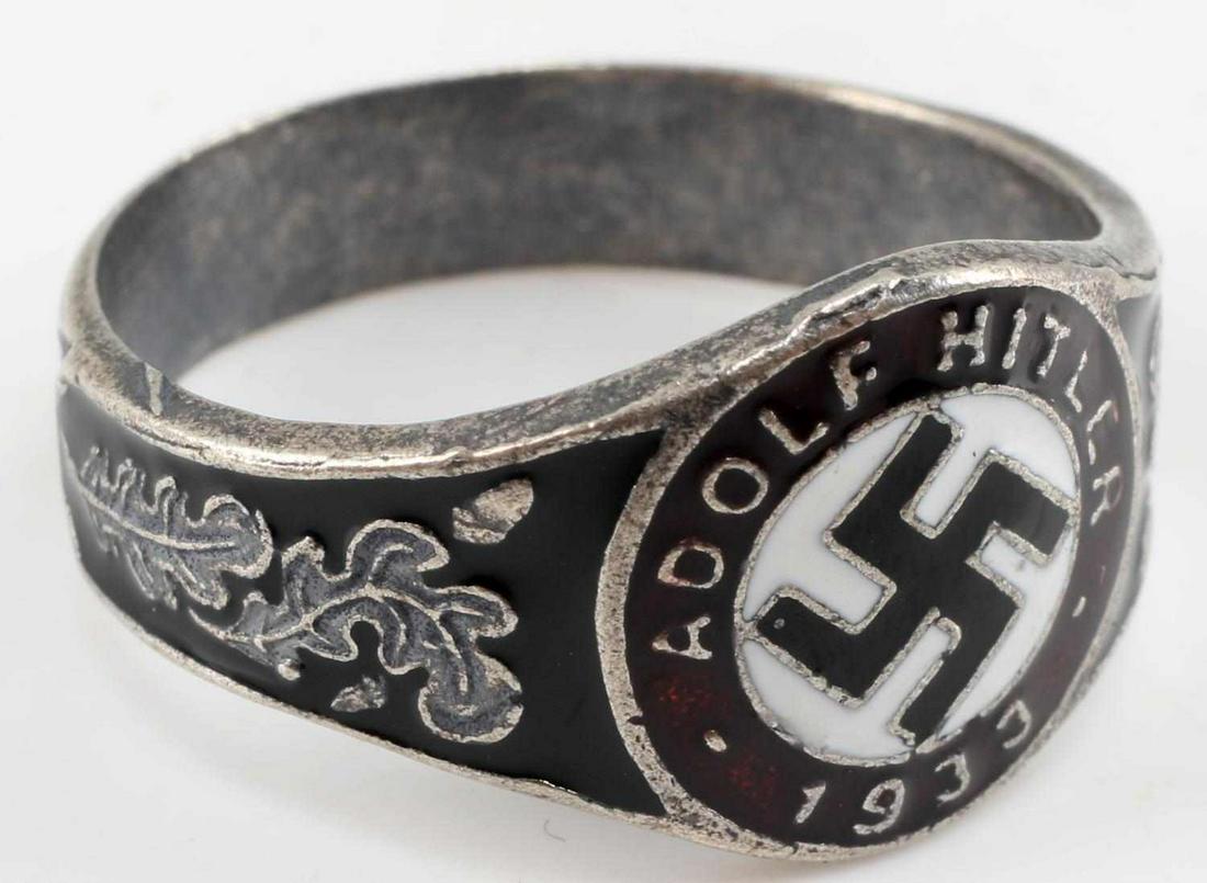 WWII GERMAN ADOLF HITLER SWASTIKA SILVER RING: Swastika to center with Hitler's name and 1933 on border, red and black enamel, and oak leaf design. Size 13, weighs 6.4 grams. Unauthenticated, sold as is. This lot has a reserve.