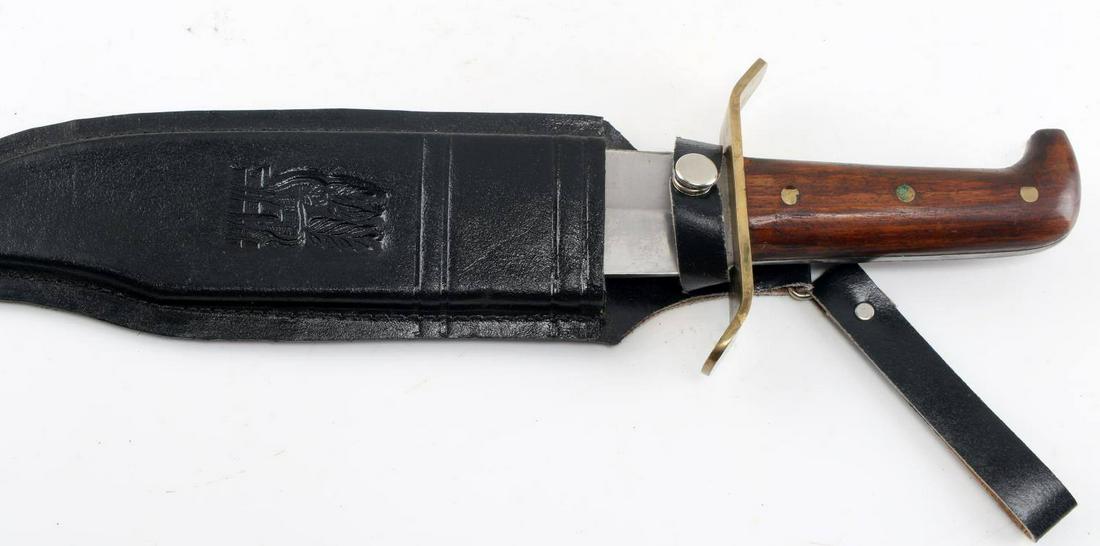 LARGE WESTERN STYLE BOWIE KNIFE W BRASS FITTINGS: Large Western Style Bowie Knife with Brass Fittings. Unmarked blade and sheath. Black leather sheath. The blade measures 9.5 inches, entire knife measures 14.75. Some oxidation on the brass crossguard