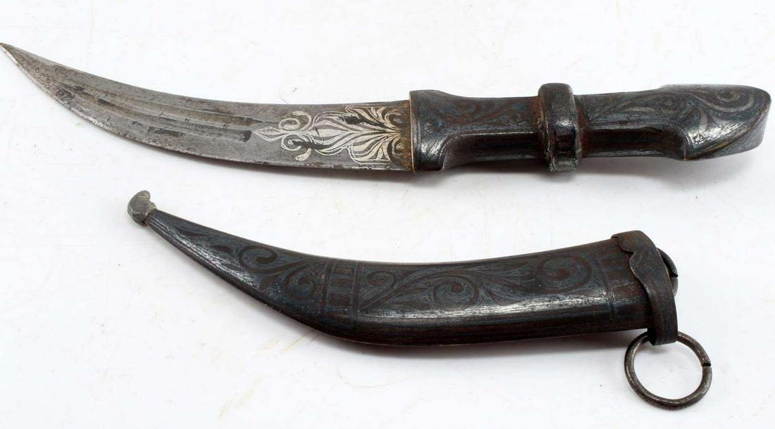 ANTIQUE PERSIAN ISLAMIC ORNATE JAMBIYA DAGGER: Antique Persian Islamic Ornate Jambiya Dagger. Complete with scabbard. Has a nice patina to the surface. The blade measures approximately 6 inches, the entire dagger measures 10.75 inches. The blade s